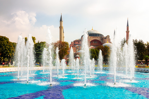istanbul, turkey - 18 aug, 2015: hagia sophia mosque behind the fountain in the sultan ahmet park