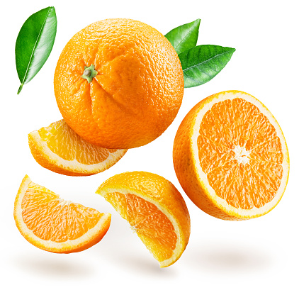 Ripe orange fruits and orange slices levitating in air on white background. File contains clipping path.