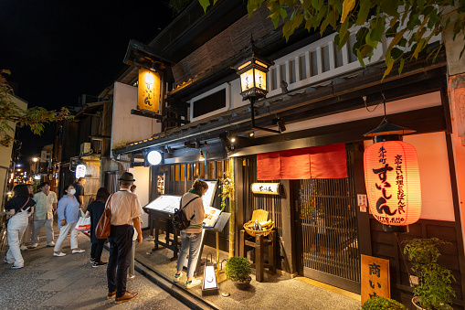 Kyoto, Japan - September 6, 2023 : People at Ponto-cho, Kyoto's most atmospheric dining areas in Hanamachi district, Kyoto, Japan. It is a narrow alley running from Shijo-dori to Sanjo-dori.