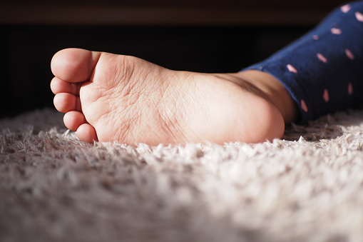 close up of dry child feet on carpet