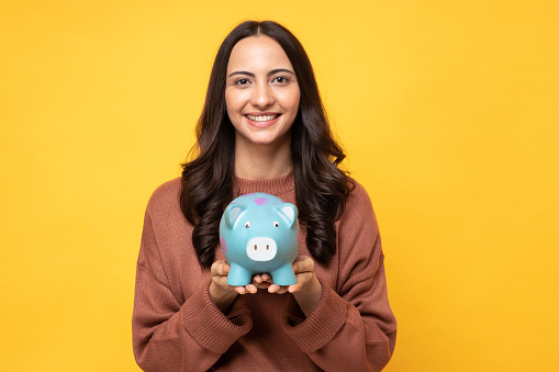 Photo of lovely person hands hold money bank pig isolated on yellow background