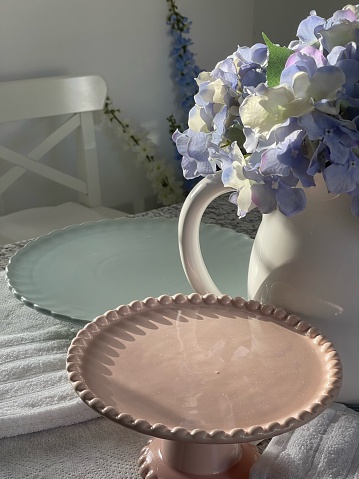 Duck egg,pale pink cake stands and white porcelain jug.