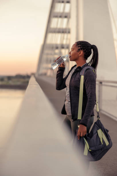 istock Woman drinking water after morning workout session 1952273516