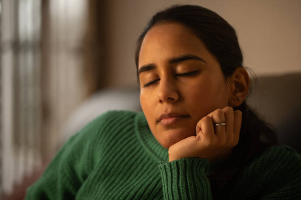 istock Woman sleeping on sofa at home 1952275624