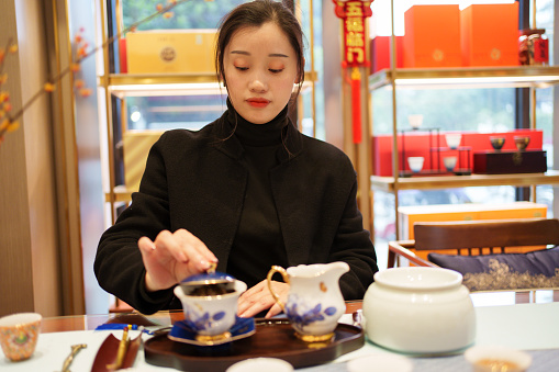 Asian woman making tea