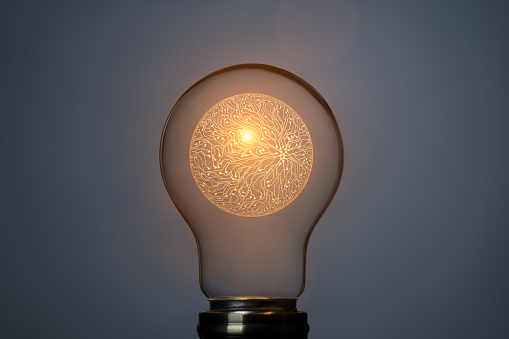 Artificial intelligence concept with sphere symbol and glowing light bulb. This file is cleaned and retouched.