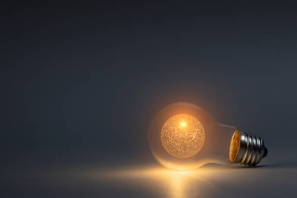 istock Artificial intelligence concept with classic light bulb glowing in the dark 1952292944