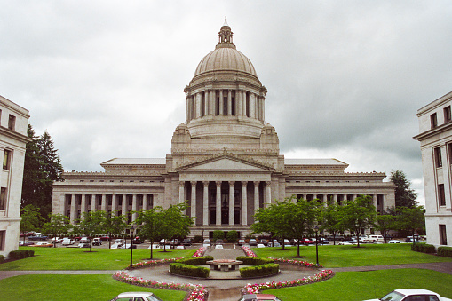 Grainy archival film photograph of the Washington State Capitol Building with cloudy sky.  Shot May 1992.