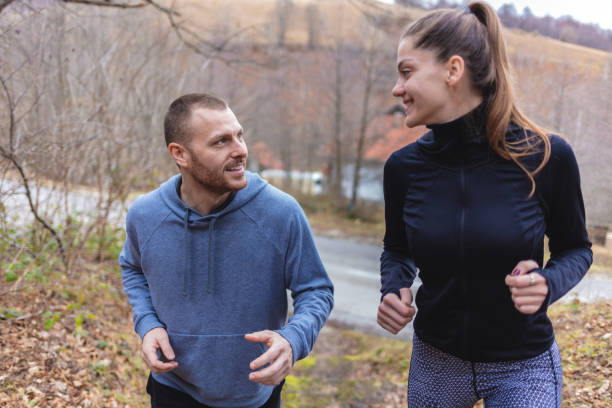 istock Healthy couple jogging in nature. 1952307848
