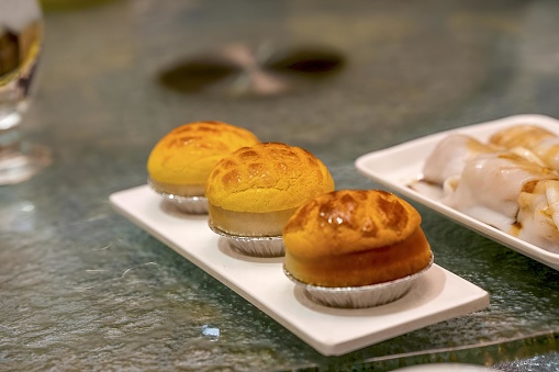 Three delectable pastries displayed on a sleek glass table