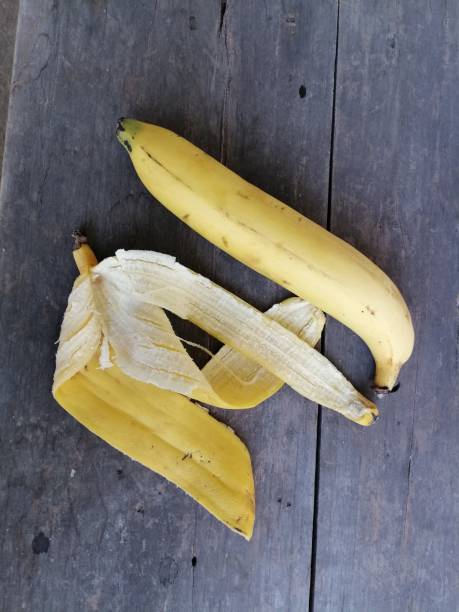 istock Peel banana on brown wood background 1952314251