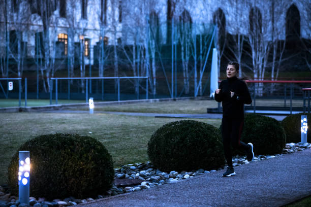 istock Woman running outdoors at night 1952316954