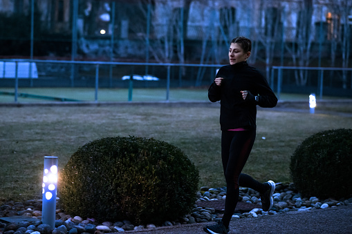 Woman running outdoors at night