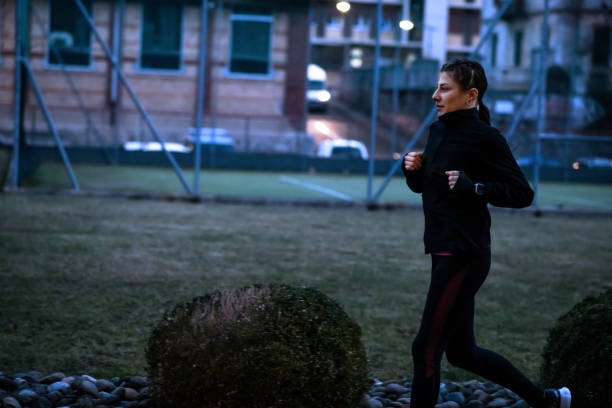 Woman running outdoors at night