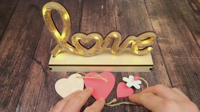 Background for Valentine's Day. Word love on wooden boards