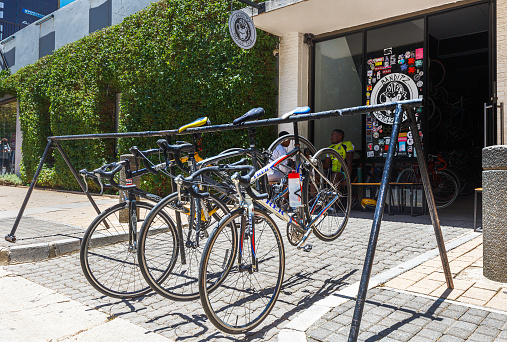 Banditz bicycle club in Braamfontein, Johannesburg with bicycles seen on a bicycle rack facing the street.