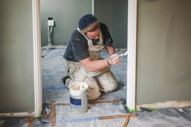 istock Young, skilled Painter & Decorator overcoming the disability of having one hand as he carefully and skilfully paints a door architrave in a residential house 1952365341