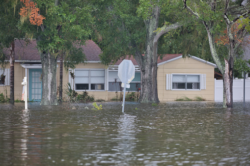 A house with a for sale sign flooded by storm surge during Hurricane Idalia in Shore Acres, a neighborhood in St. Petersburg, Florida