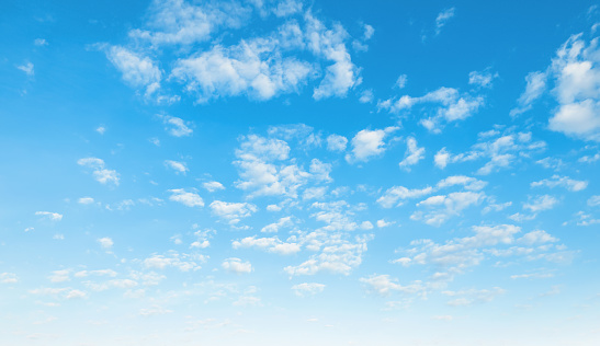 Fluffy clouds and clear blue sky background in summer