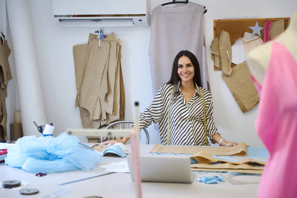istock Craftswoman in striped blouse at her workplace at cutting table 1952375306
