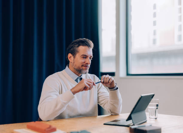 istock Corporate Focus: Businessman and His Tablet 1952380802