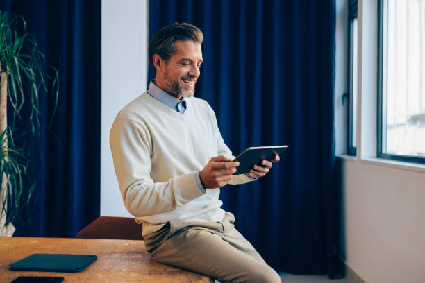 istock Corporate Focus: Businessman and His Tablet 1952381036
