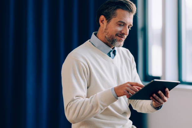 istock Corporate Focus: Businessman and His Tablet 1952381047
