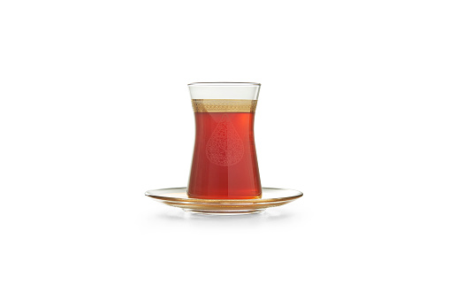 Turkish tea is in the glass cup and plate, isolated white background.