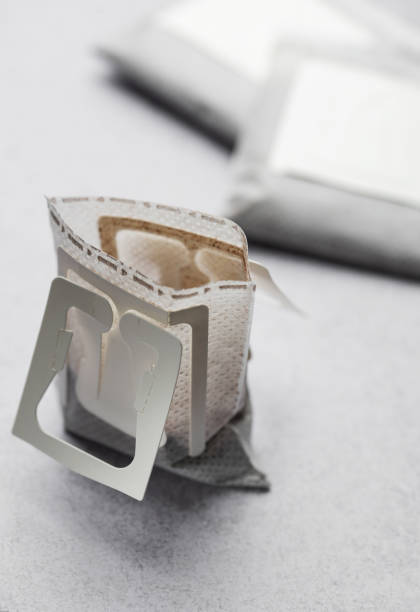 Drip coffee paper bags on a grey concrete background