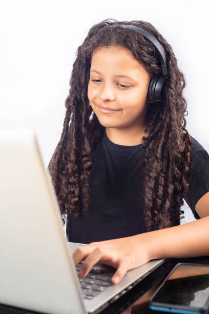 istock Teenage Brazilian woman using technology, white background, selective focus. 1952396133