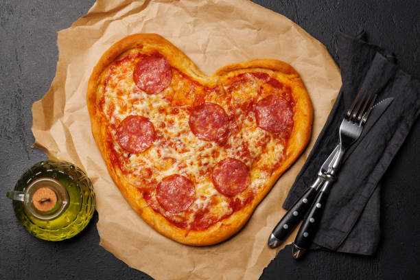istock Heart-shaped pizza: Delicious love-themed dish 1952398841