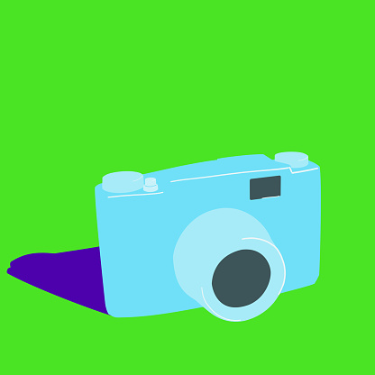 Minimalist style analog photo camera on a green background with a shadow on one side
