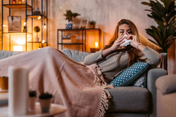 istock Young Sick Woman Sneezing At Home At Night 1952414038