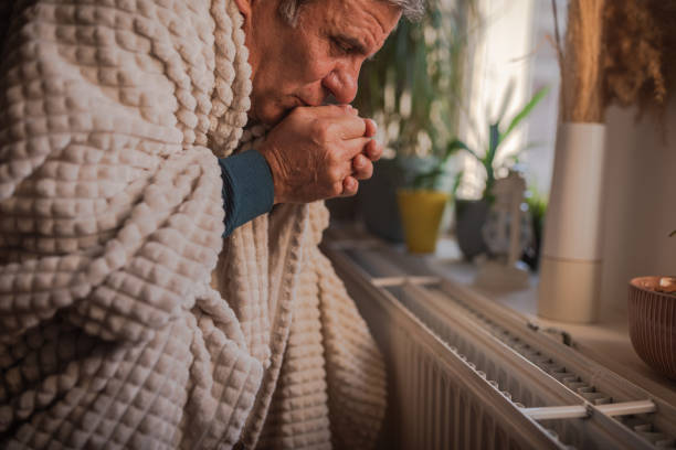 istock Energy crisis, man feels the cold next to the radiator 1952414554