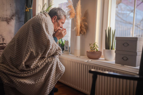 istock Energy crisis, man feels the cold next to the radiator 1952415085