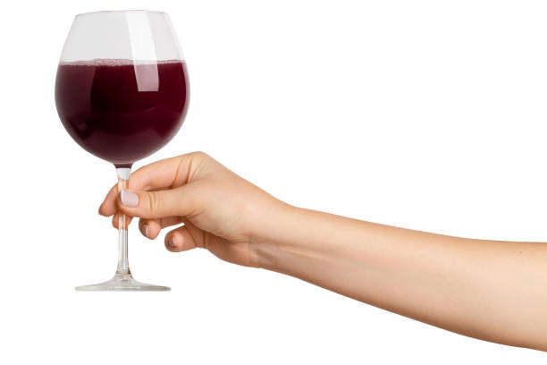 istock A woman's hand holds. Glass with red wine. On a blank background 1952417280