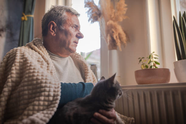 istock Energy crisis, man feels the cold next to the radiator 1952418350