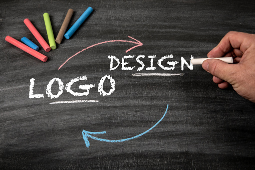 LOGO and DESIGN Concept. Black scratched textured chalkboard background