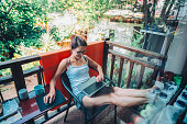 Woman at the terrace working during her summer vacation