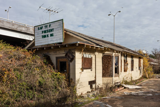 istock Boarded up industrial office building sitting abandoned on manufacturing site 1952431066