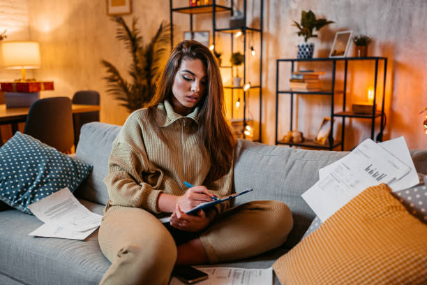 istock Young Woman Checking Her Finances At Home At Night 1952432510