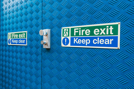 Fire exit sign at blue metal door