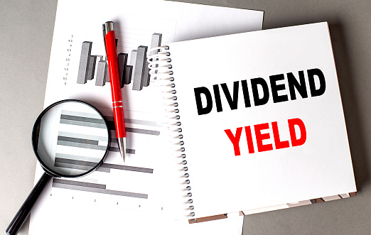 DIVIDEND YIELD text written on a notebook with chart