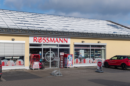 Wernberg-Köblitz, Germany - January 19, 2024: Store of the drugstore chain Rossmann in the German town Wernberg-Köblitz, Upper Palatinate, Bavaria, Germany. Founded by Dirk Rossmann in 1972 with seat in Burgwedel. Logo and advertising on the facade and the panes. Sunny january day.