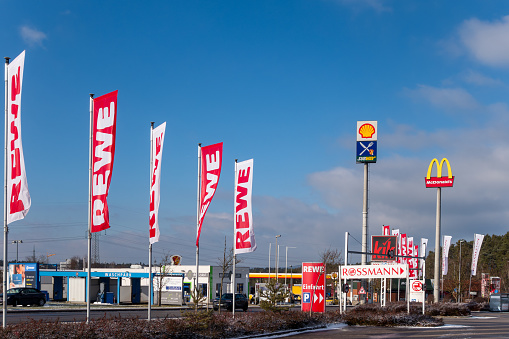 Wernberg-Köblitz, Germany - January 19, 2024: Advertising in the commercial area on the A 93 motorway, exit 27 Wernberg-Köblitz. Brand names represented there include McDonalds, Shell, Subway, REWE, kik, Conrad, Rossmann. Sunny January day.