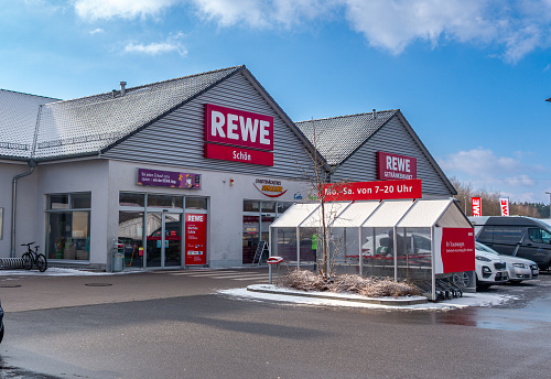 Wernberg-Köblitz, Germany - January 19, 2024: Store of the supermarket chain REWE located in the commercial area on the A 93 motorway, exit 27 Wernberg-Köblitz.Bavaria. REWE is the second largest food retailer in Germany. Sunny january day.