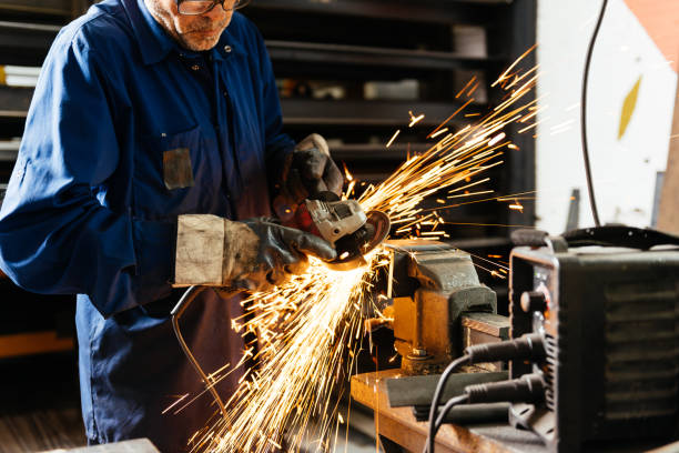 istock Crop worker working with grinder in workshop at factory 1952509173