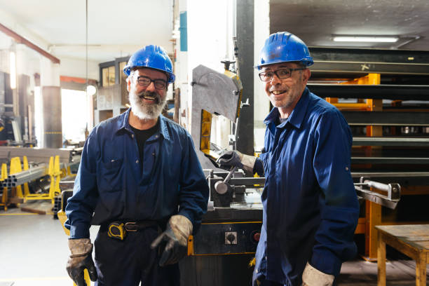 istock Smiling professional workers standing in factory workshop 1952515613