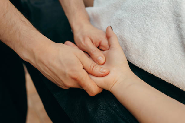 istock Male hands massaging a female palm 1952516176
