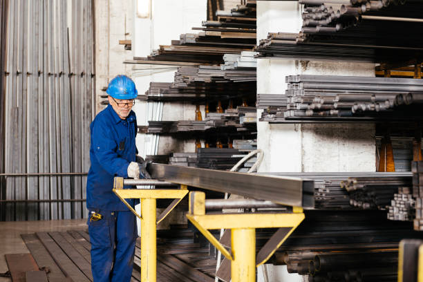 istock Man working with metal beam in factory warehouse 1952518920